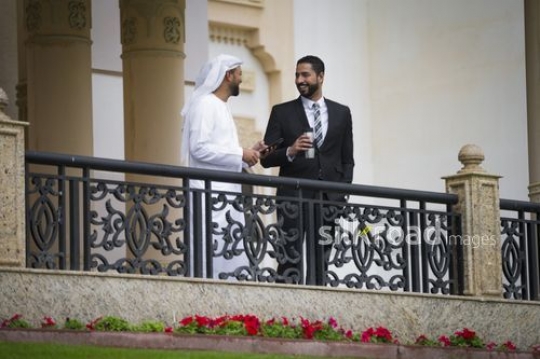 Businessmen standing together on the bridge|-