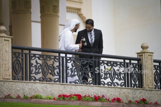 Businessmen standing on the bridge laughing together|-
