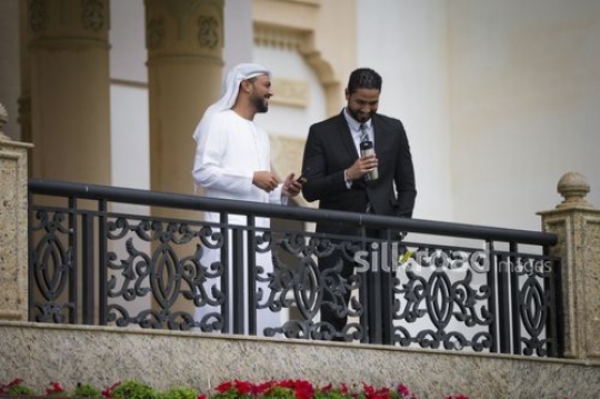 Middle Eastern Businessmen standing on the bridge laughing together|-