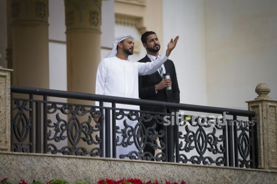 Middle Eastern Businessmen standing on the bridge talking to each other|-