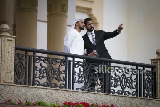 Businessmen standing on the bridge talking to each other|-