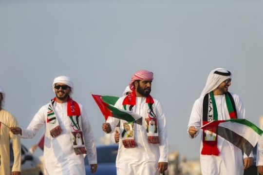 Middle eastern men participating in a National Day Parade|-