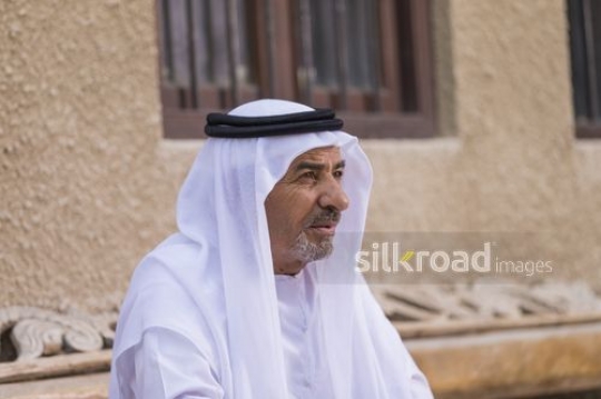 Close up of Arab man sitting on the bench|-