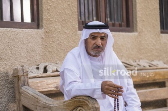 Arab grandfather sitting on the bench with his misbahah|-