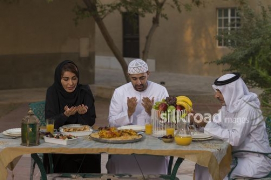 REPLACE - Middle Eastern family praying before Iftar|-