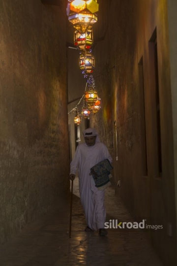 Middle Eastern man walking through the alleyway of the Ramadan Lanterns|-
