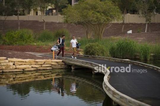 Middle Eastern men carrying Golf bags walking at the Golf Resort|-