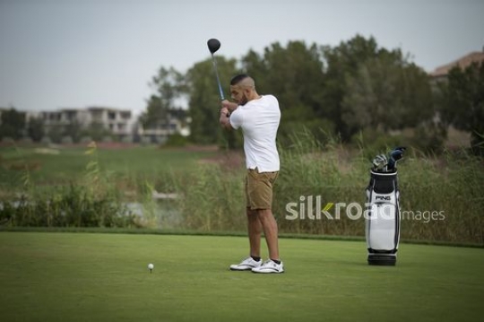 Young man playing golf|-
