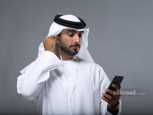 Arab Man fixing earphones