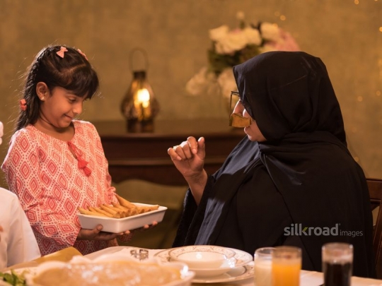 Girl serving grandmother|-
