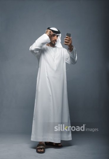 Businessman fixing traditional head cover