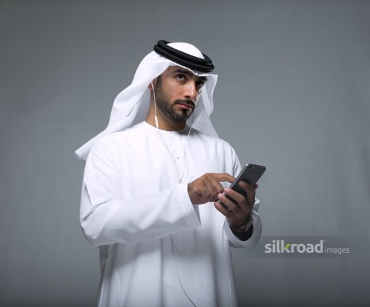 Businessman using mobile looking ahead