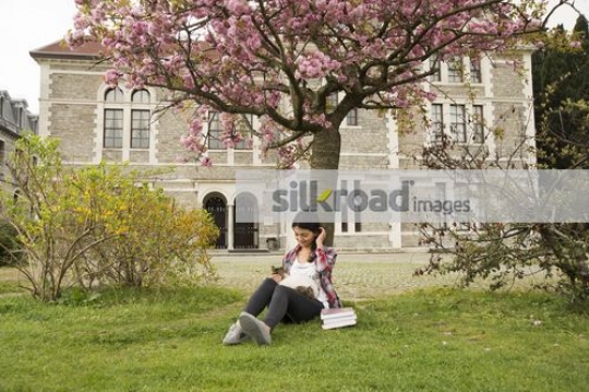 Woman sitting on campus with the cat on her lap|