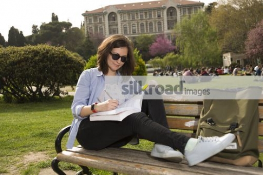 University Student sitting on the bench studying|