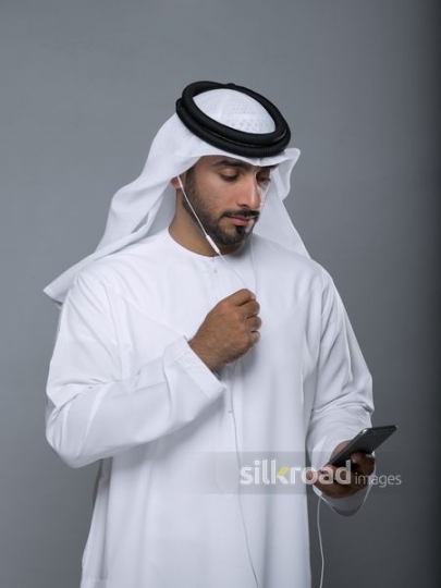 Arab man talking on the phone using earphones