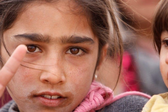 closeup kid showing victory sign