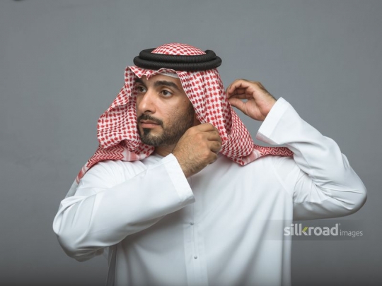 Arabian man fixing his head cover