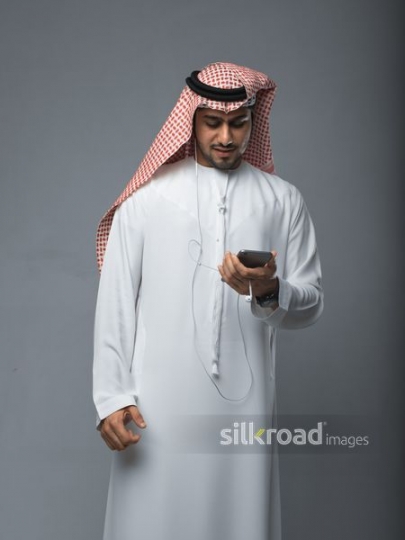 Young Emirati checking his mobile phone