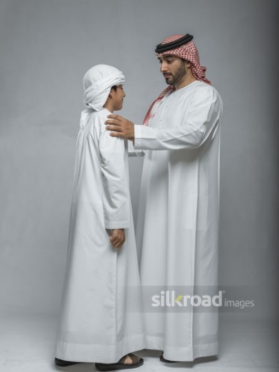Young Arab boy talking to the Arab man