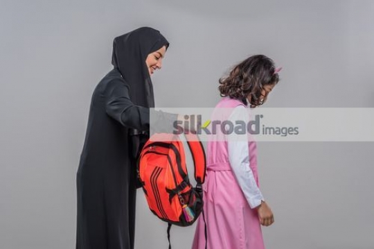 Arab mother taking the girls school bag