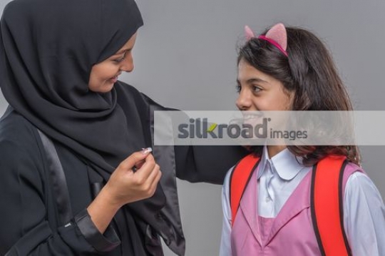 Close up of a Middle Eastern woman talking to the young kid|