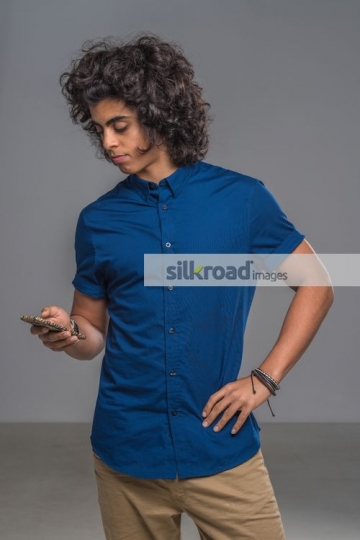 Middle Eastern teenager texting|