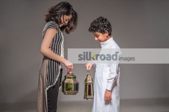 Middle Eastern kids carrying the Ramadan Lantern|