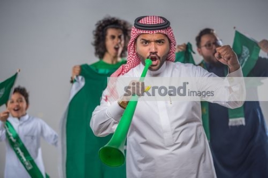 Middle Eastern family celebrating their country|