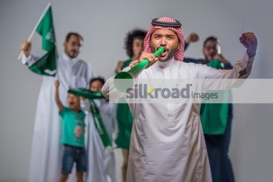 Middle Eastern men and kids celebrating together|