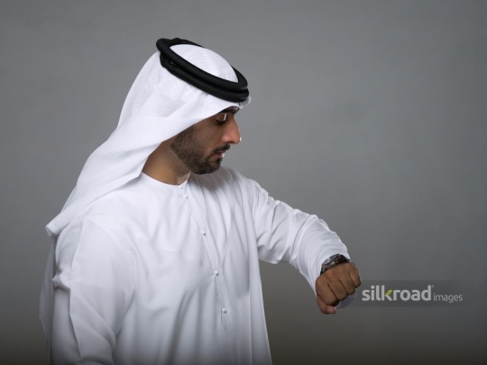 Arabian man checking time