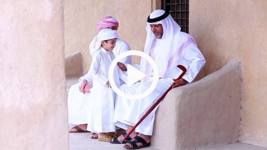 Boys greeting father during Eid