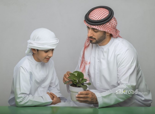 Father teaching his son about plants