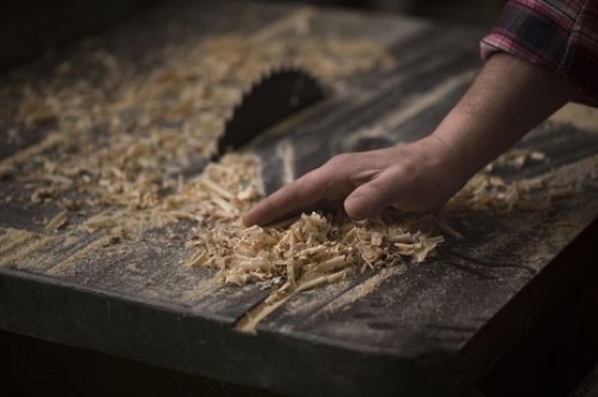 Man cleaning the wood dust