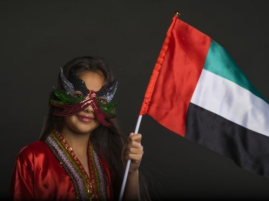 Stylish Emirati girl carrying flag