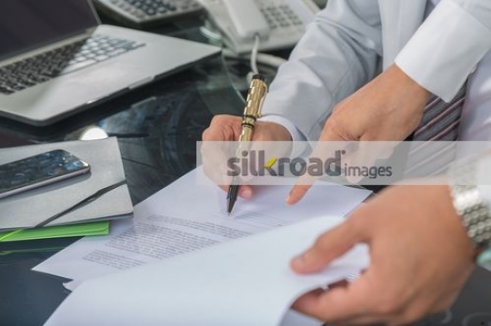 Businessman signing paper