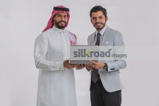 Arab Businessmen standing with the laptop|