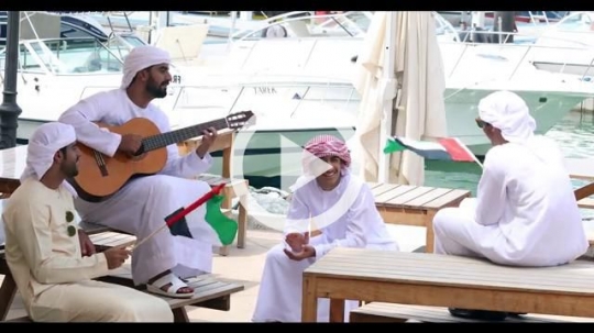 Arab men sitting together and playing with the guitar |