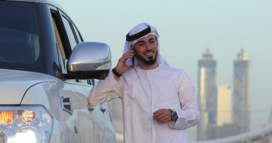 Arab Businessman dials a number and talks on the phone |-