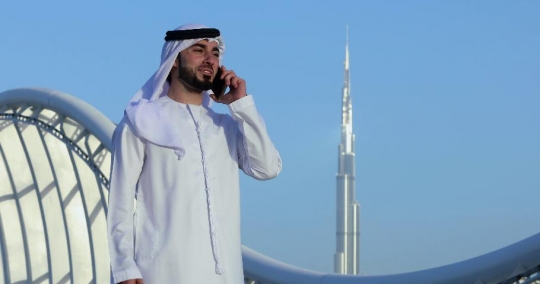 Arab man talking on the phone|-