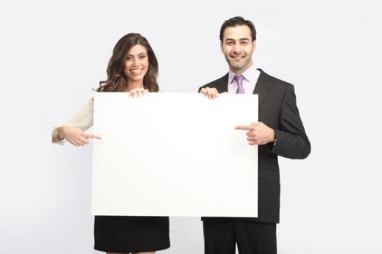 Businessman and Businesswoman Holding a board