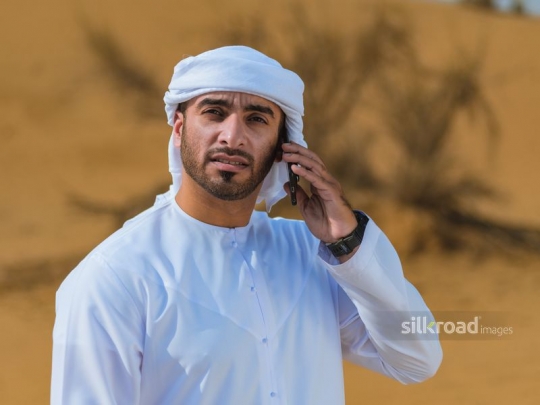 Emirati talking over the phone