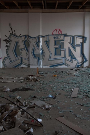 wall graffiti with broken glass on floor