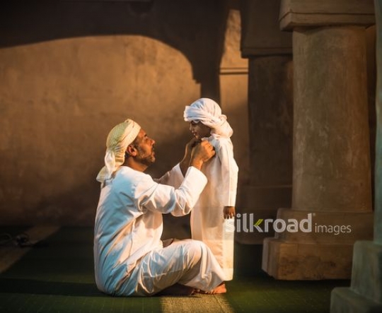 Kid with grandfather at the mosque|-