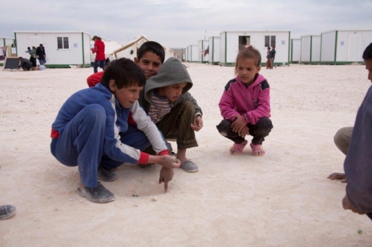 group of children playing glass ball from Zaatari refugee camp for Syrian refugees