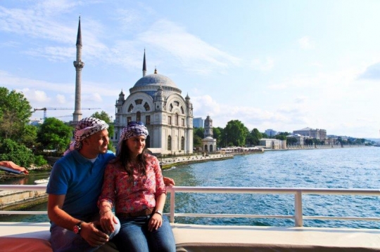 people taking photo in front of a mosque
