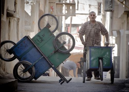 man pushes a cart