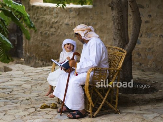 Grandfather sitting outside with grandson|-