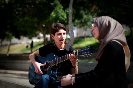 Palestinian Youth Playing Guit