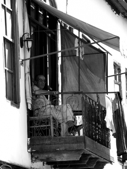 man sitting in balcony