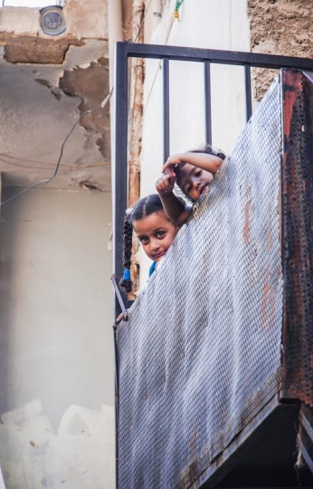 two little girls standing on balcony